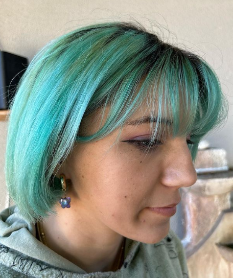 Blue Highlighted Bob With Wispy Bangs Hairstyle