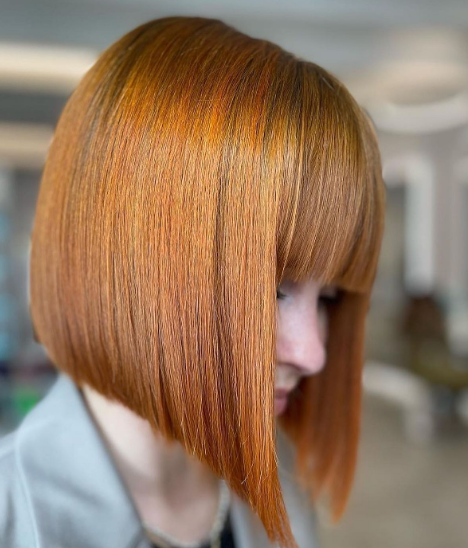 Copper-Colored Straight Bangs And Fringe Middle Part Bob