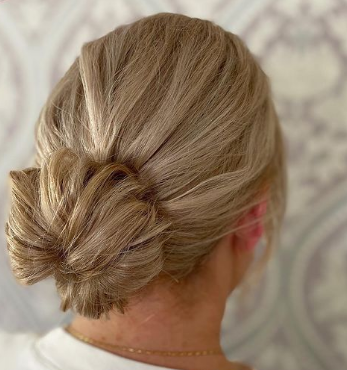 Slightly Textured Low Bun Hairstyle For Wedding Guests