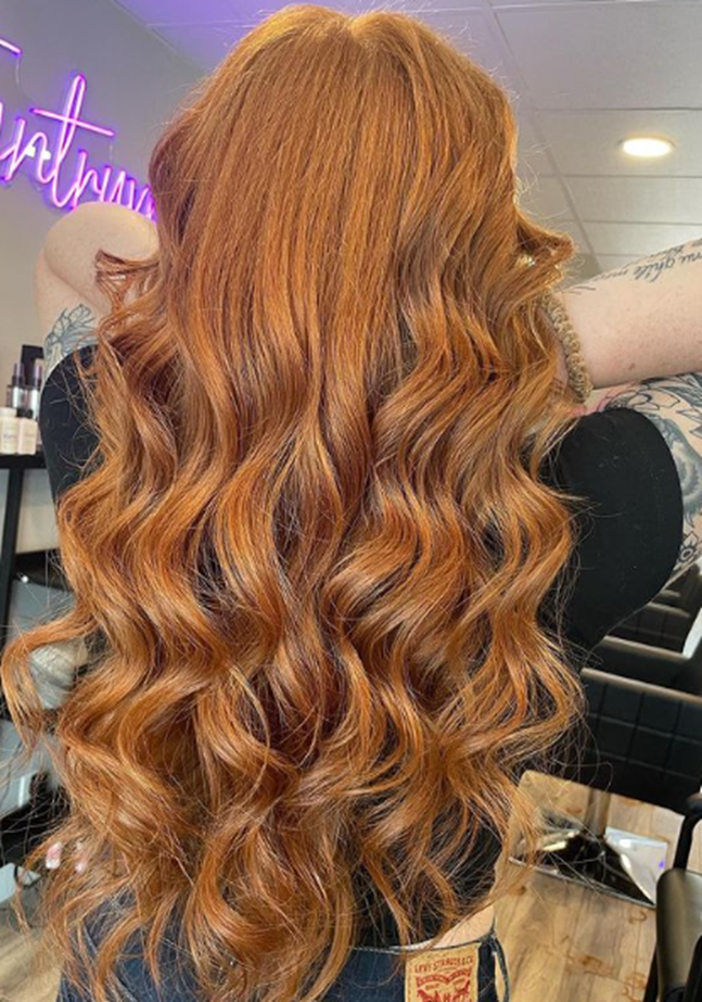 Honey Blonde Curly And Wavy Long Layered Hairstyle