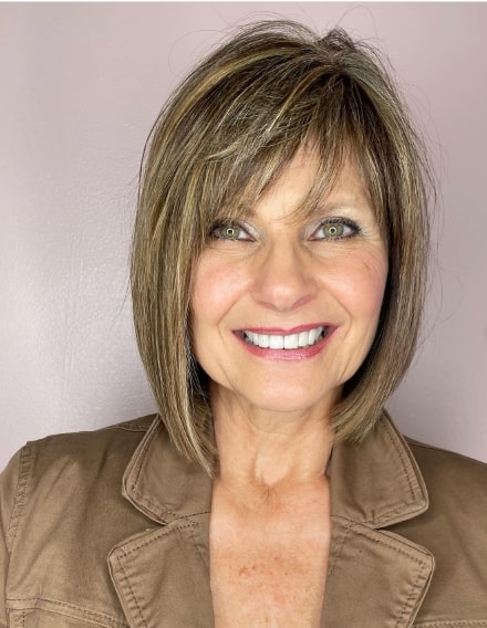 Natural Highlights Hairstyle For Women Over 50 With Bangs