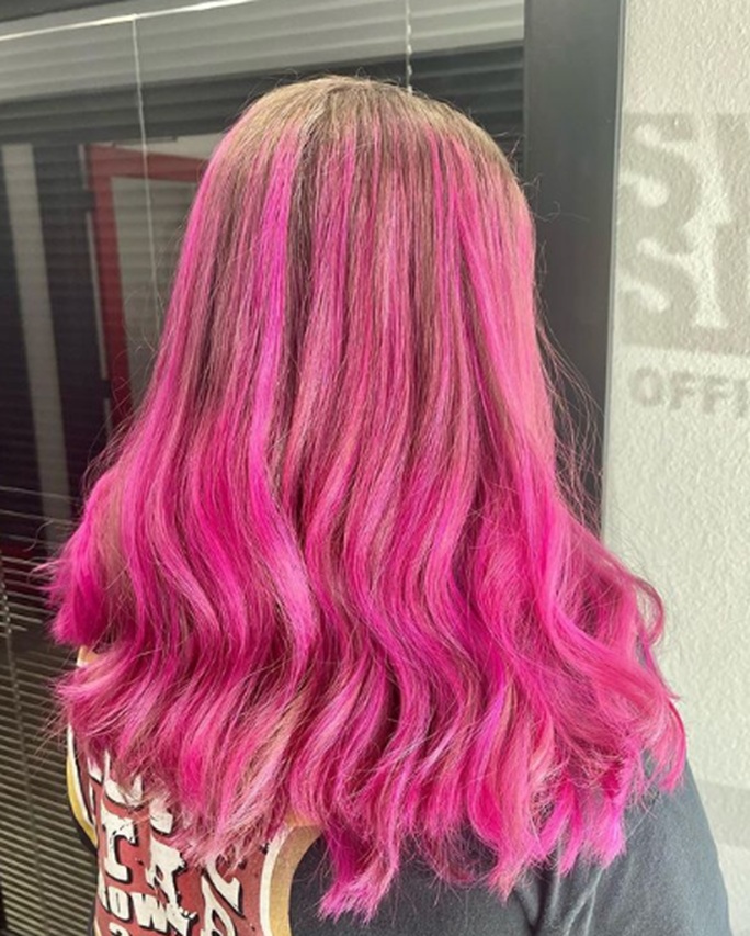 Rooted Blonde With Pink Colored Long Layered Hairstyle